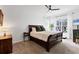 Inviting main bedroom features a sleigh bed, soft carpet, and bright windows with curtains at 5806 43Rd E Ct, Bradenton, FL 34203