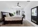 Spacious main bedroom features a sleigh bed, neutral carpet, a ceiling fan and bright windows at 5806 43Rd E Ct, Bradenton, FL 34203