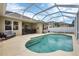 Backyard screened-in pool area with tanning ledge, outdoor seating, and a covered patio at 5806 43Rd E Ct, Bradenton, FL 34203