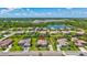 Aerial view of a home in a community with mature landscaping, sidewalks and nearby lake views at 604 166Th E St, Bradenton, FL 34212