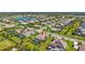 Expansive aerial view of a suburban community, highlighting neat streets, green lawns, and community pond at 604 166Th E St, Bradenton, FL 34212