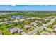 Community aerial showcasing the neighborhood, mature trees, and large pond in a desirable location at 604 166Th E St, Bradenton, FL 34212