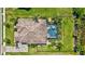 Overhead view of the home featuring a tile roof, screened pool, and well-maintained landscaping at 604 166Th E St, Bradenton, FL 34212
