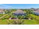 Aerial view of the home showcasing a screened pool area, fenced yard, and tropical landscaping at 604 166Th E St, Bradenton, FL 34212
