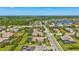 Aerial view of a home in a planned community with lush greenery, serene ponds, and well-maintained streets at 604 166Th E St, Bradenton, FL 34212