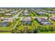 Aerial view showcasing a home with a pool, lush landscaping, and a well-planned neighborhood at 604 166Th E St, Bradenton, FL 34212