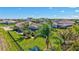 A charming backyard with palm trees, tropical landscaping, and a metal fence at 604 166Th E St, Bradenton, FL 34212