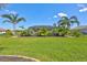 Expansive backyard with lush greenery, featuring a screened-in pool area and tropical landscaping at 604 166Th E St, Bradenton, FL 34212