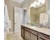 Bathroom with granite countertop and stainless steel faucet and decorative mirror at 604 166Th E St, Bradenton, FL 34212