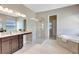 Luxurious bathroom featuring a glass shower, soaking tub, and double vanity at 604 166Th E St, Bradenton, FL 34212