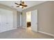 Bedroom with carpet, ceiling fan, closet, and ensuite bathroom at 604 166Th E St, Bradenton, FL 34212