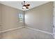 Empty bedroom with neutral walls, carpet, ceiling fan, and natural light at 604 166Th E St, Bradenton, FL 34212