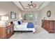 Relaxing bedroom retreat with tray ceilings, neutral walls, soft carpet, and ample natural light from windows at 604 166Th E St, Bradenton, FL 34212