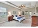 Relaxing bedroom retreat with tray ceilings, neutral walls, soft carpet, and ample natural light from windows at 604 166Th E St, Bradenton, FL 34212