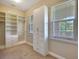 Walk in closet features built in storage shelves and drawers with two window for natural light at 604 166Th E St, Bradenton, FL 34212