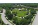 Aerial view of a meticulously maintained park, featuring walking paths, sports areas and lush green spaces at 604 166Th E St, Bradenton, FL 34212