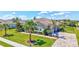 Landscaped light gray home featuring a tile roof, with palm trees enhancing its curb appeal at 604 166Th E St, Bradenton, FL 34212