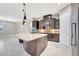Open kitchen showcasing a large island, custom cabinets, and pendant lighting at 604 166Th E St, Bradenton, FL 34212