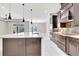 Modern kitchen featuring a large island, stainless steel appliances, and pendant lights at 604 166Th E St, Bradenton, FL 34212