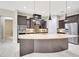 Well-equipped kitchen with a curved island, granite countertops, and custom cabinets at 604 166Th E St, Bradenton, FL 34212