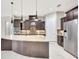 Well-equipped kitchen with a curved island, granite countertops, and custom cabinets at 604 166Th E St, Bradenton, FL 34212