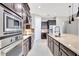 Chef's kitchen featuring stainless appliances, tile backsplash and island sink at 604 166Th E St, Bradenton, FL 34212