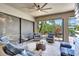 Inviting lanai with comfortable seating, offering a relaxing outdoor space with serene views and a ceiling fan at 604 166Th E St, Bradenton, FL 34212