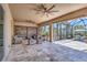 Spacious covered lanai with seating area offers view of pool and beautiful landscaping at 604 166Th E St, Bradenton, FL 34212