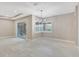 Spacious living room with tile floors, sliding doors, and modern chandelier at 604 166Th E St, Bradenton, FL 34212