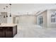 Open living space with tray ceiling, recessed lights, and sliding glass doors at 604 166Th E St, Bradenton, FL 34212