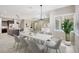 Open-concept living and dining area with modern chandelier and window shutters at 604 166Th E St, Bradenton, FL 34212