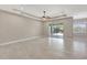 Bright living room boasts tile floors, recessed lighting, and sliding glass doors to covered patio at 604 166Th E St, Bradenton, FL 34212