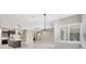 Bright living space featuring modern lighting, neutral walls, and tiled flooring at 604 166Th E St, Bradenton, FL 34212
