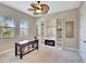 Home office featuring built-in shelving, electric fireplace, desk, and ceiling fan at 604 166Th E St, Bradenton, FL 34212