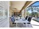 Covered patio with dining area, seating, and views of the pool and landscaping at 604 166Th E St, Bradenton, FL 34212