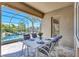 Outdoor dining on the covered patio features a view of the pool area through a screened enclosure at 604 166Th E St, Bradenton, FL 34212