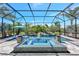 Screened-in pool area with lush landscaping, integrated waterfall, and relaxing spa at 604 166Th E St, Bradenton, FL 34212