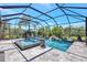 Stunning screened pool with waterfall features, spa, and lush tropical landscaping at 604 166Th E St, Bradenton, FL 34212