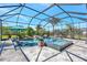 Gorgeous screened pool and spa area with waterfall features, lounge chairs, and lush tropical landscaping at 604 166Th E St, Bradenton, FL 34212