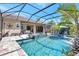 The screened-in pool and spa offer a relaxing retreat with waterfall feature and outdoor seating area at 604 166Th E St, Bradenton, FL 34212