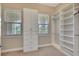 Spacious walk-in closet featuring built-in shelving units, ample storage space, and natural light from windows at 604 166Th E St, Bradenton, FL 34212