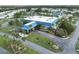 Aerial view showcasing the community center with manicured landscaping and ample parking at 617 Cervina S Dr, Venice, FL 34285