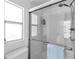 Clean bathroom with glass shower door, modern fixtures, and tiled walls at 617 Cervina S Dr, Venice, FL 34285