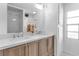 Bathroom featuring a dual sink vanity with wood cabinets, quartz countertop, and modern faucets at 617 Cervina S Dr, Venice, FL 34285