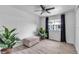 Spare bedroom with wood look floors, ceiling fan, and black out curtains at 617 Cervina S Dr, Venice, FL 34285