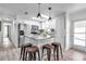Bright kitchen with stainless steel appliances, white cabinets, center island with seating and skylight at 617 Cervina S Dr, Venice, FL 34285