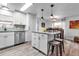 Modern kitchen features stainless steel appliances, white cabinetry, and a center island with stool seating at 617 Cervina S Dr, Venice, FL 34285