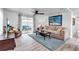 Bright living room with a comfortable seating, stylish décor, and sliding glass doors to the outside at 617 Cervina S Dr, Venice, FL 34285
