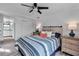 Comfortable bedroom with ceiling fan, dual nightstands, and light wood-look floors at 617 Cervina S Dr, Venice, FL 34285
