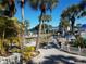 Community pool area surrounded by lush greenery, a tennis court, and inviting walkways at 617 Cervina S Dr, Venice, FL 34285